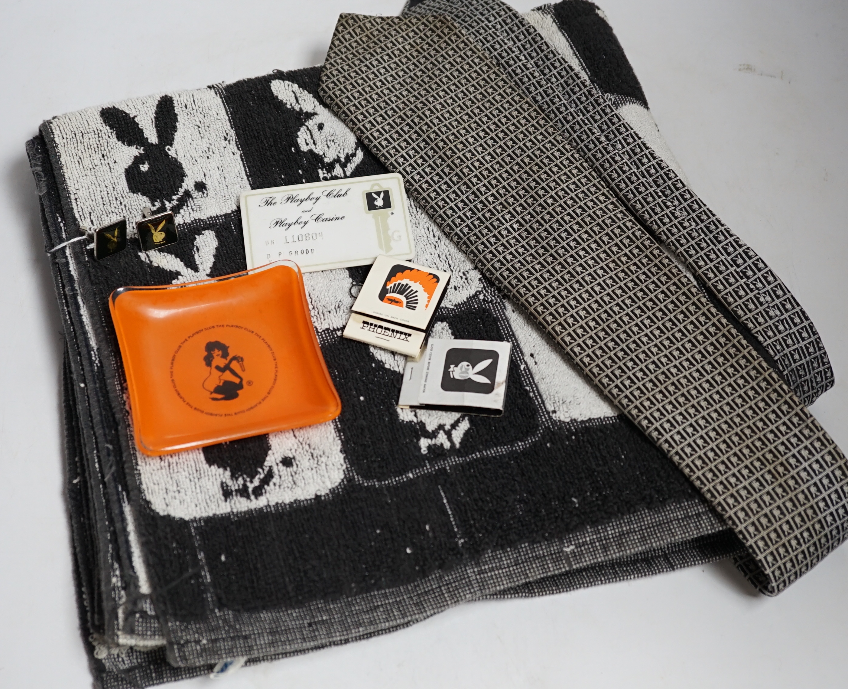 Playboy memorabilia: tie, an ashtray, two packs of matches, towel, a pair of cuff-links, membership card